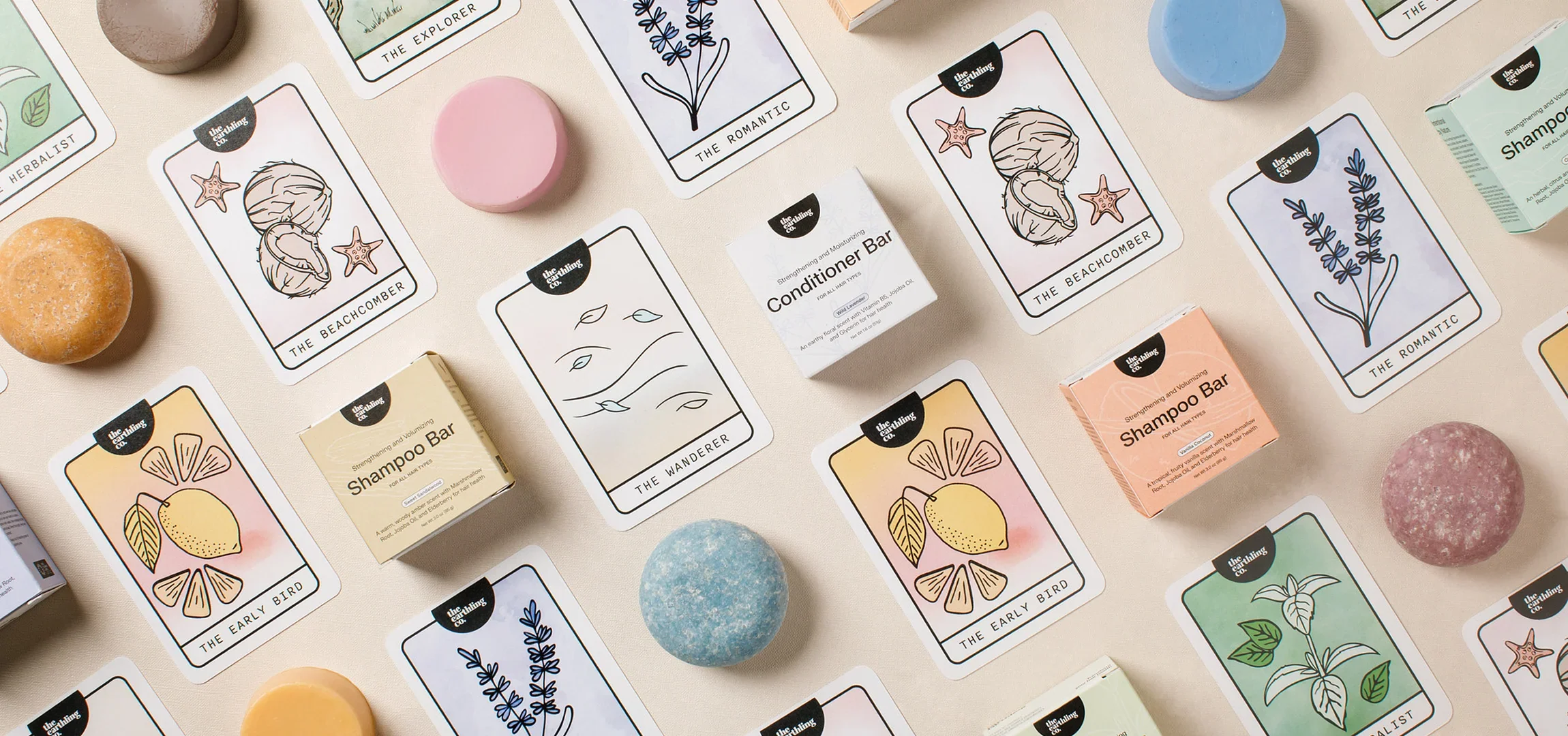 Scent cards, shampoo bars and boxes laid out on cream fabric